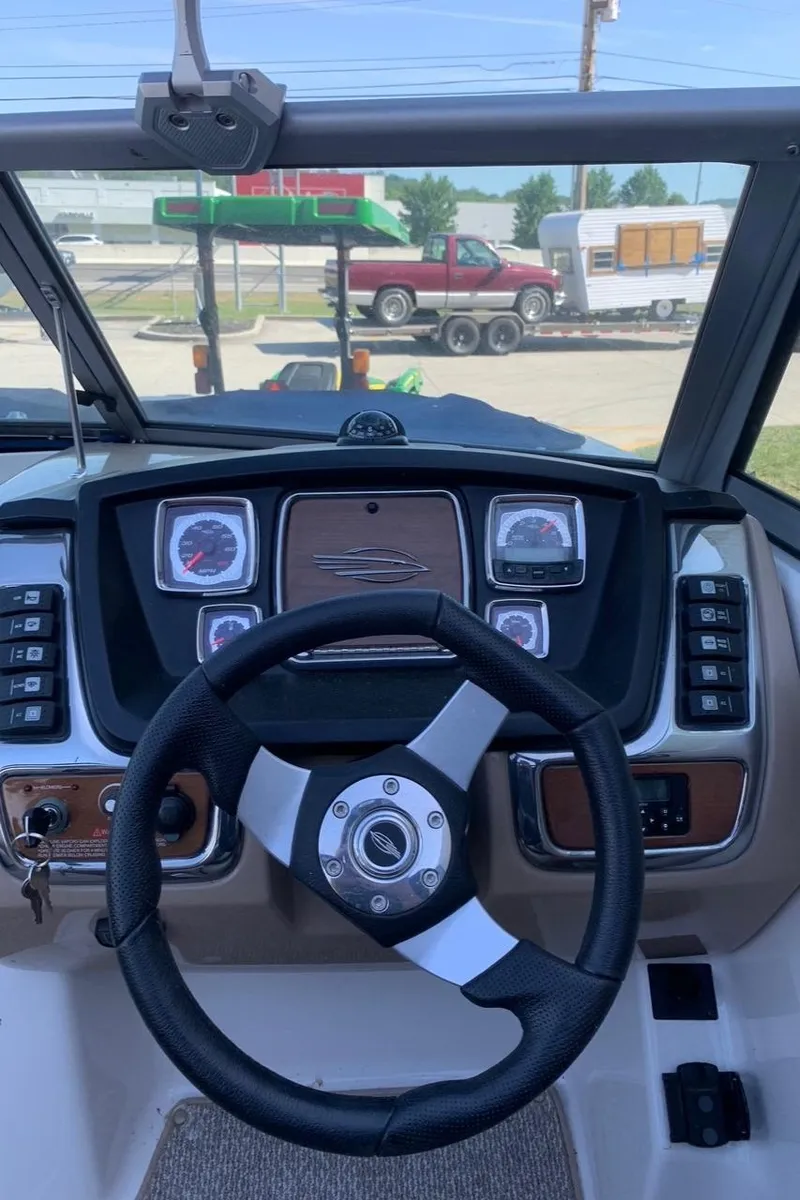 Slide: The Image of 2012 Chaparral 224 Sunesta boat dashboard with steering wheel and gauges. - 4