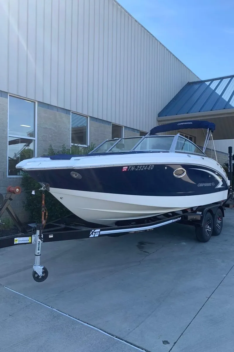 Slide: The Image of 2012 Chaparral 224 Sunesta boat on trailer outside a building. - 5
