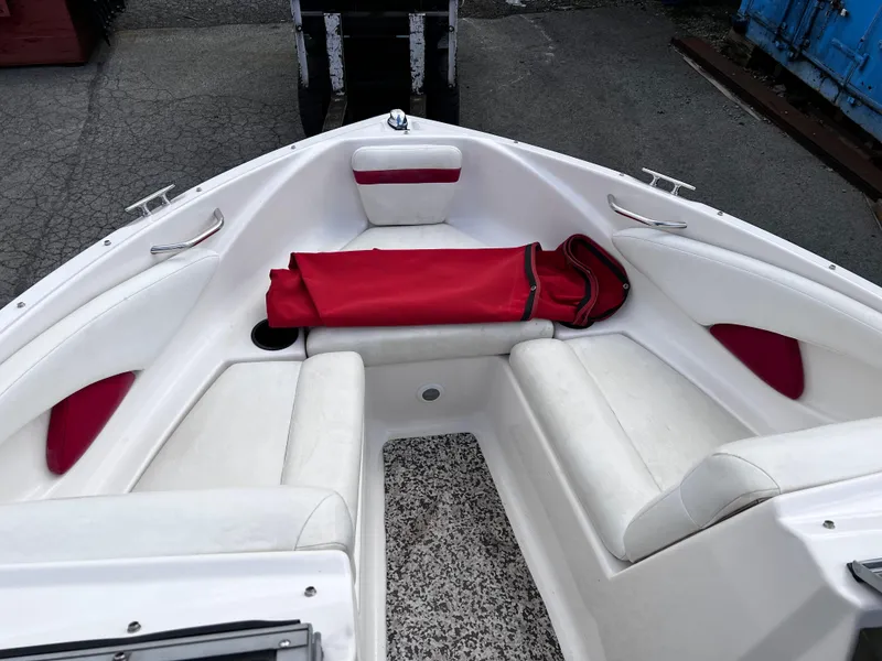 Slide: The Image of 2006 Regal 1900 Bowrider boat interior with white seating and red accents. - 8