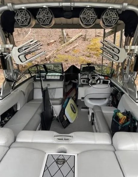 Slide: The Image of 2015 MasterCraft X23 boat interior with wakeboard racks and premium seating. - 10