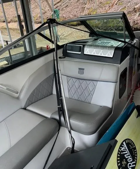 Slide: The Image of 2015 MasterCraft X23 boat interior with gray seating and diamond stitching. - 16