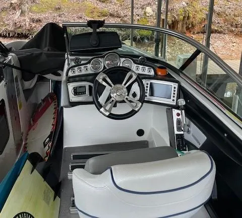 Slide: The Image of 2015 MasterCraft X23 boat cockpit with steering wheel and control panel. - 18