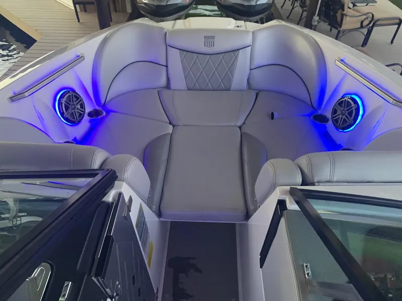 Slide: The Image of 2015 MasterCraft X23 boat interior with blue LED lights and premium seating. - 22