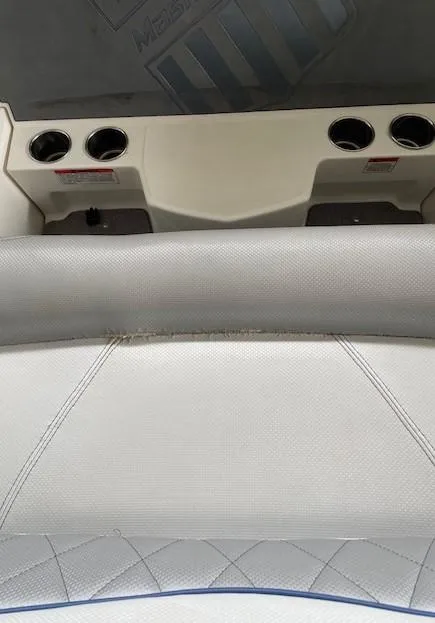 Slide: The Image of 2015 MasterCraft X23 boat interior with cup holders and cushioned seating. - 25