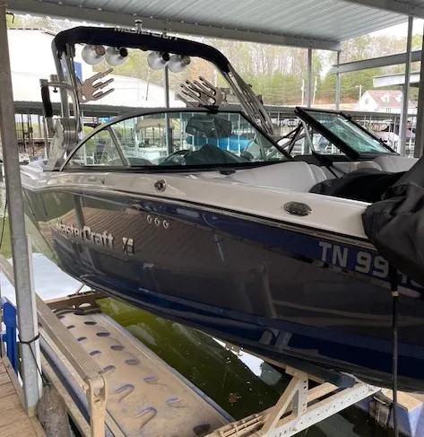 Slide: The Image of 2015 MasterCraft X23 boat docked, featuring sleek design and modern wakeboard tower. - 7
