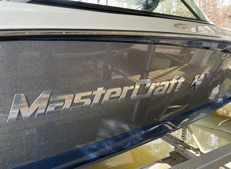 Slide: The Image of 2015 MasterCraft X23 boat with metallic finish, close-up of logo. - 9