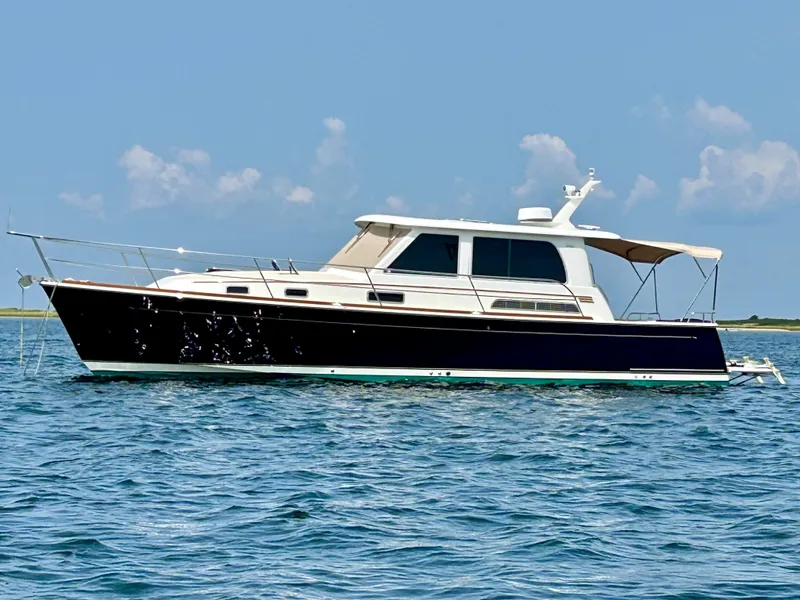 Slide: The Image of 2017 Sabre 42 Salon Express yacht on calm blue water under clear sky. - 0