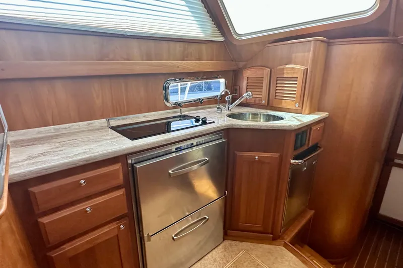 Slide: The Image of 2017 Sabre 42 Salon Express galley with wood cabinetry and modern appliances. - 11