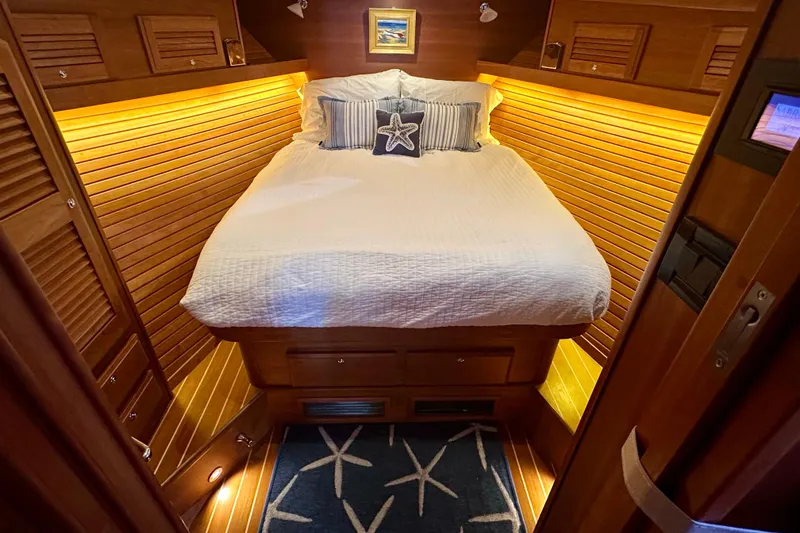 Slide: The Image of Cozy cabin interior of 2017 Sabre 42 Salon Express with warm lighting and nautical decor. - 13