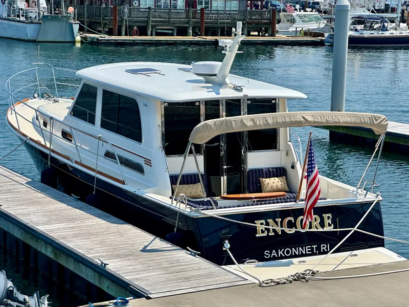 Slide: The Image of 2017 Sabre 42 Salon Express yacht docked at marina, featuring sleek design and American flag. - 2