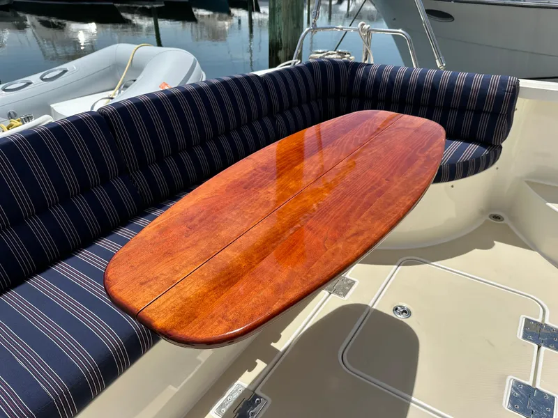 Slide: The Image of 2017 Sabre 42 Salon Express yacht with striped seating and polished wooden table. - 4
