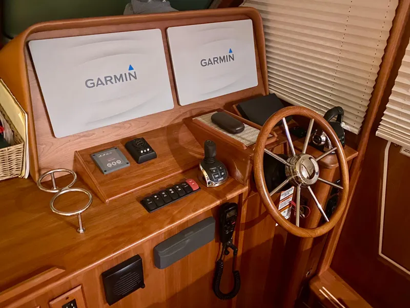 Slide: The Image of Helm of 2017 Sabre 42 Salon Express with Garmin navigation displays and wooden steering wheel. - 6