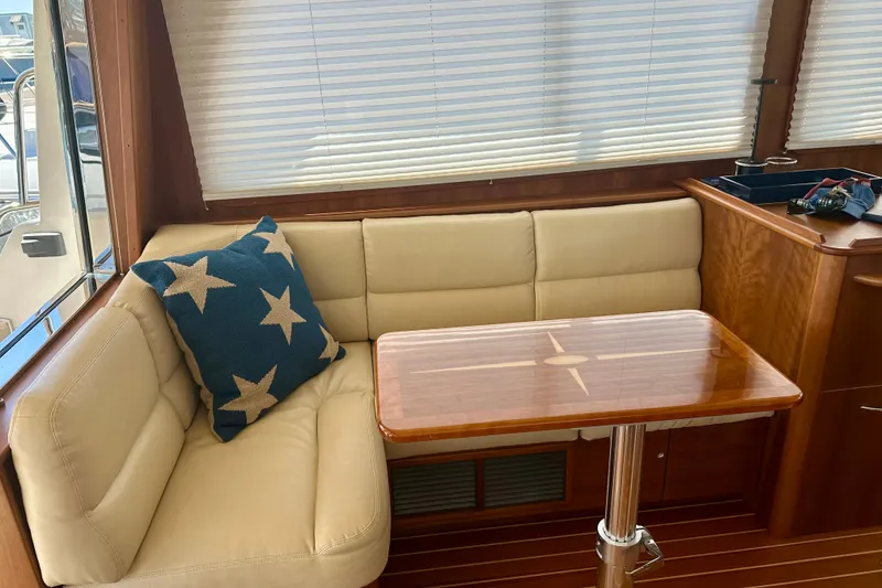 Slide: The Image of Interior of 2017 Sabre 42 Salon Express with beige seating and star-patterned pillow. - 9