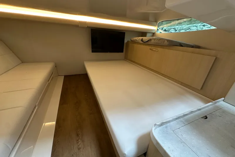 Slide: The Image of 2026 Regal 38 SAV cabin interior with modern design, featuring a bed, sofa, and TV. - 22