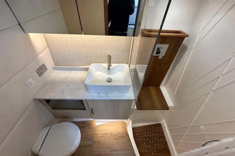 Slide: The Image of Modern bathroom in 2026 Regal 38 SAV yacht with sleek sink and wooden accents. - 26