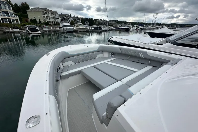 Slide: The Image of 2026 Regal 38 SAV boat with luxurious seating in a serene marina setting. - 27