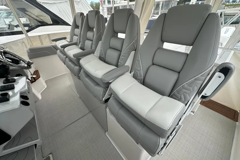 Slide: The Image of Luxurious seating on 2026 Regal 38 SAV boat, featuring plush gray and white upholstery. - 32