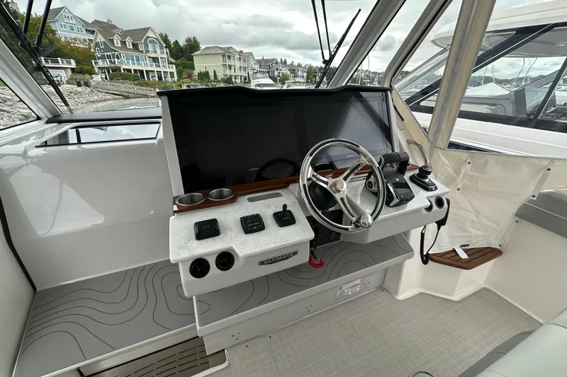 Slide: The Image of Helm of 2026 Regal 38 SAV boat with modern controls and steering wheel. - 33