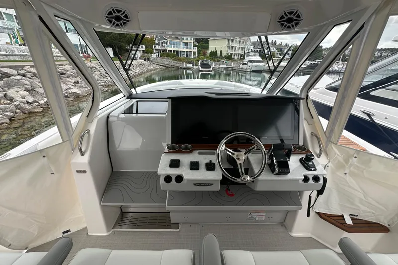 Slide: The Image of 2026 Regal 38 SAV boat helm with modern controls and spacious cockpit view. - 34