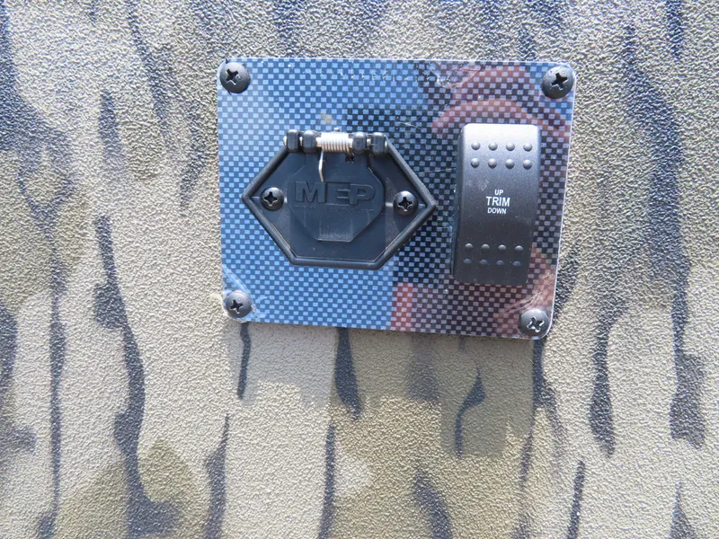 Slide: The Image of Control panel on 2024 SeaArk Shadow 19v CC boat with camouflage design. - 11