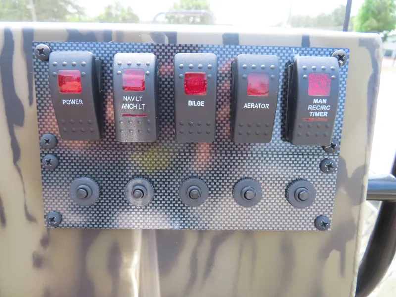 Slide: The Image of Control panel of 2024 SeaArk Shadow 19v CC boat with labeled switches. - 5