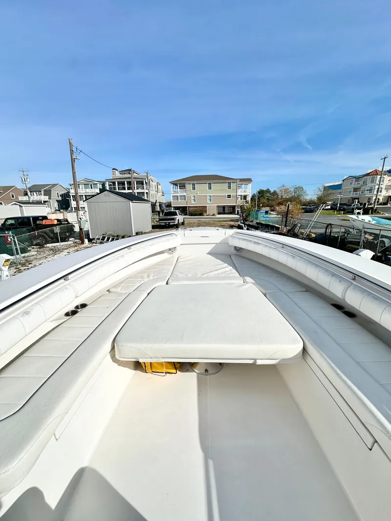 Slide: The Image of 2015 Regulator 34 boat with spacious deck and seating, docked in a marina. - 10