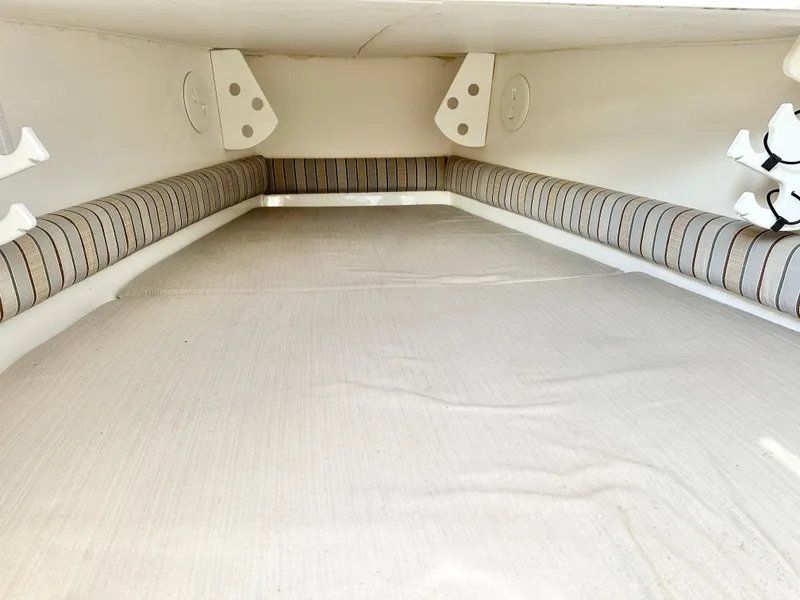 Slide: The Image of 2015 Regulator 34 boat interior with cushioned seating and storage space. - 16