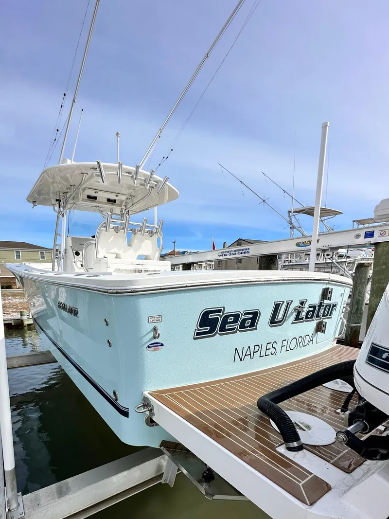 Slide: The Image of 2015 Regulator 34 boat docked in Naples, Florida, with "Sea U Later" on the stern. - 3