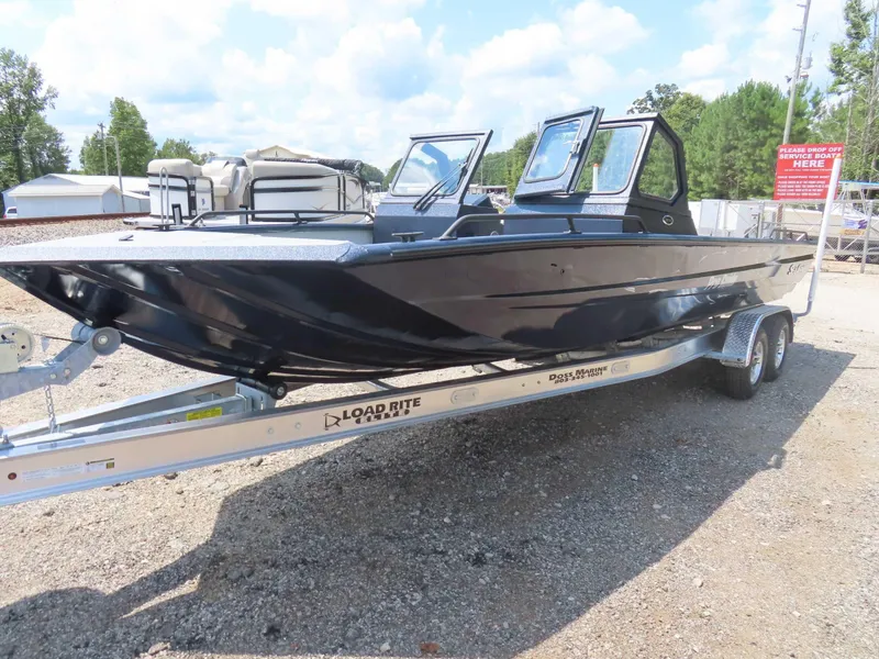 Slide: The Image of 2024 SeaArk Pro Guide 2672 boat on Load Rite trailer, parked outdoors. - 1