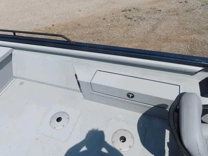 Slide: The Image of 2024 SeaArk Pro Guide 2672 boat interior with storage compartment and seating. - 10