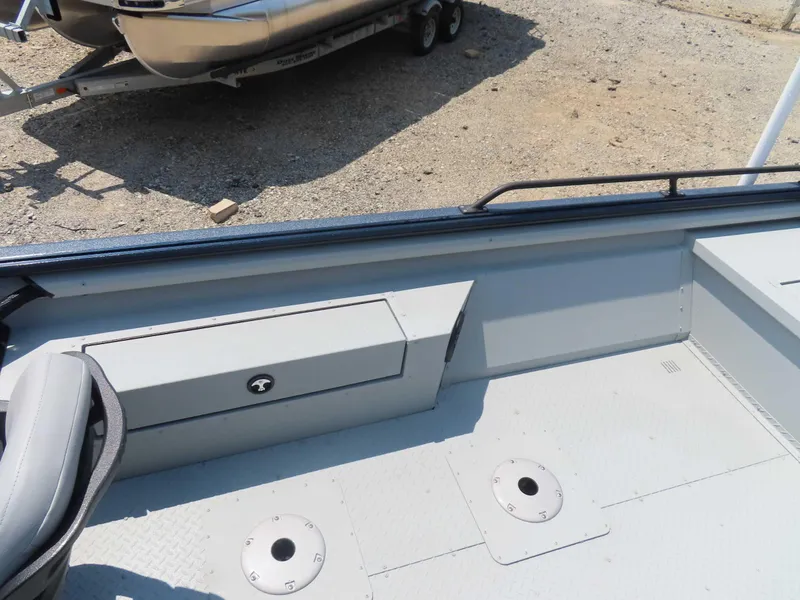 Slide: The Image of 2024 SeaArk Pro Guide 2672 boat interior with seating and storage compartments. - 11