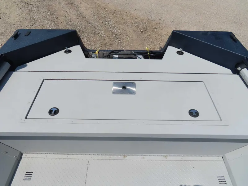 Slide: The Image of 2024 SeaArk Pro Guide 2672 boat deck with storage compartment, viewed from above. - 13