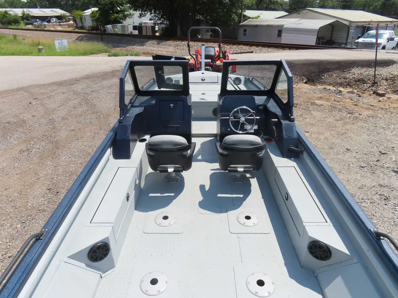 Slide: The Image of 2024 SeaArk Pro Guide 2672 boat interior with dual seats and steering wheel. - 14