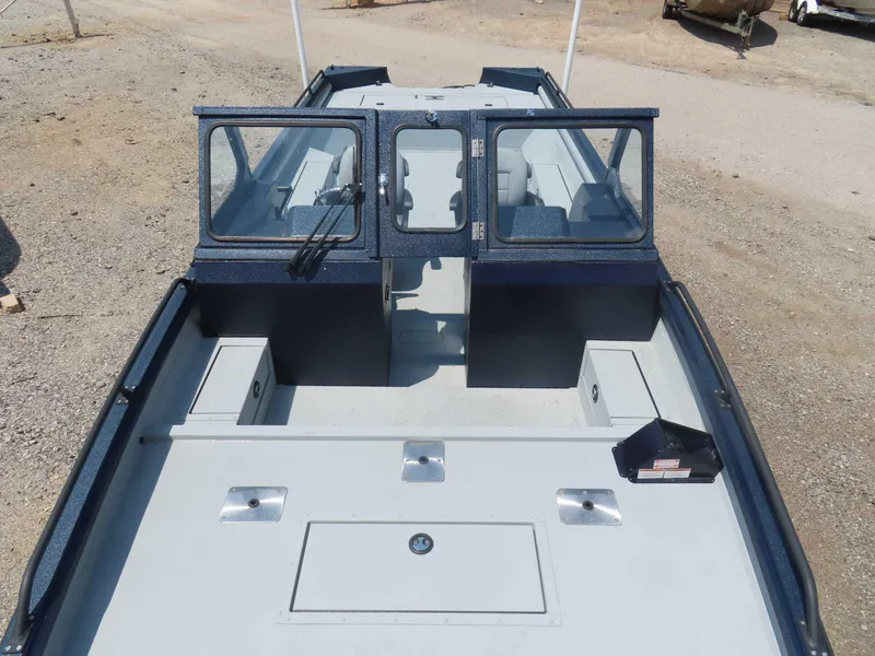 Slide: The Image of 2024 SeaArk Pro Guide 2672 boat, spacious interior, dual windshields, outdoor setting. - 21