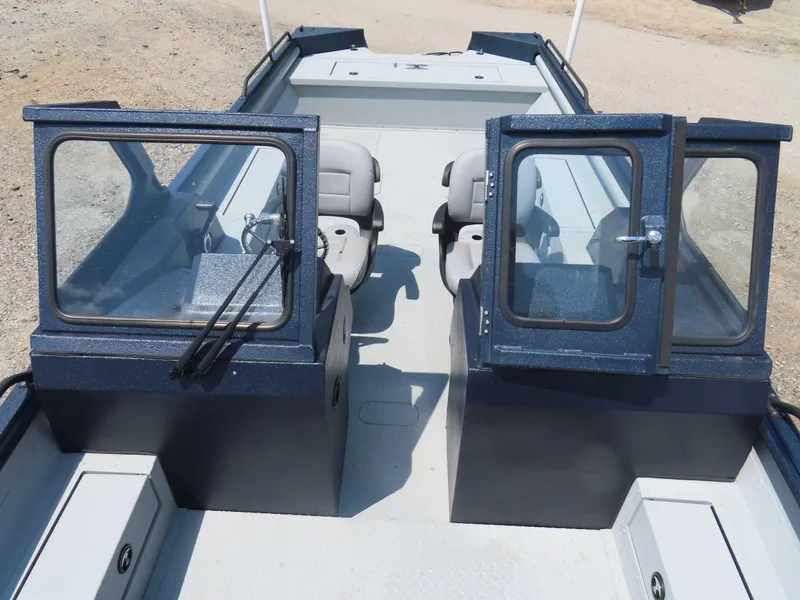 Slide: The Image of 2024 SeaArk Pro Guide 2672 boat interior with dual windshields and seating. - 3