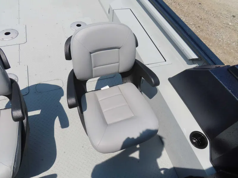 Slide: The Image of 2024 SeaArk Pro Guide 2672 boat seat with armrests on deck. - 6