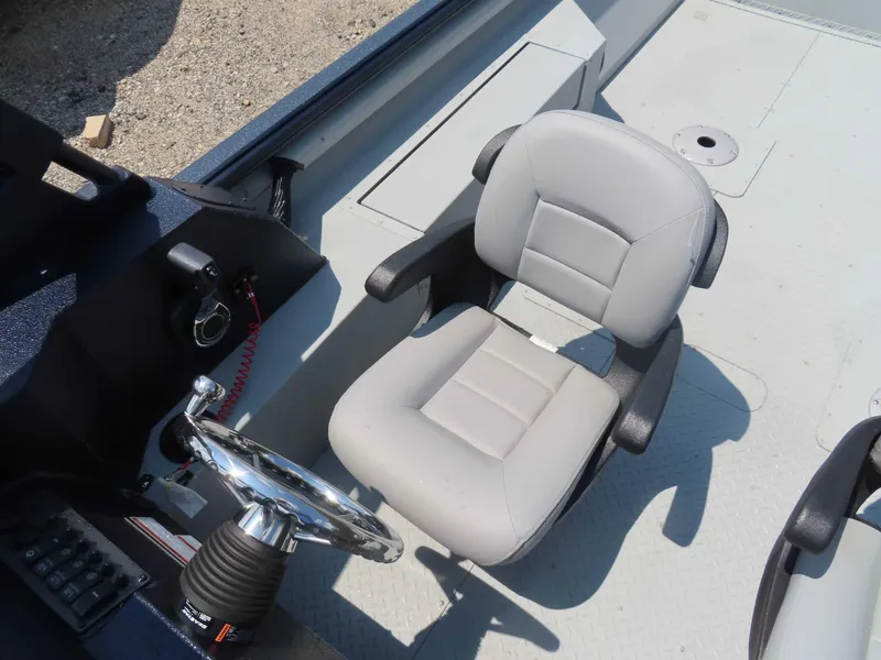 Slide: The Image of 2024 SeaArk Pro Guide 2672 boat interior with steering wheel and seat. - 7