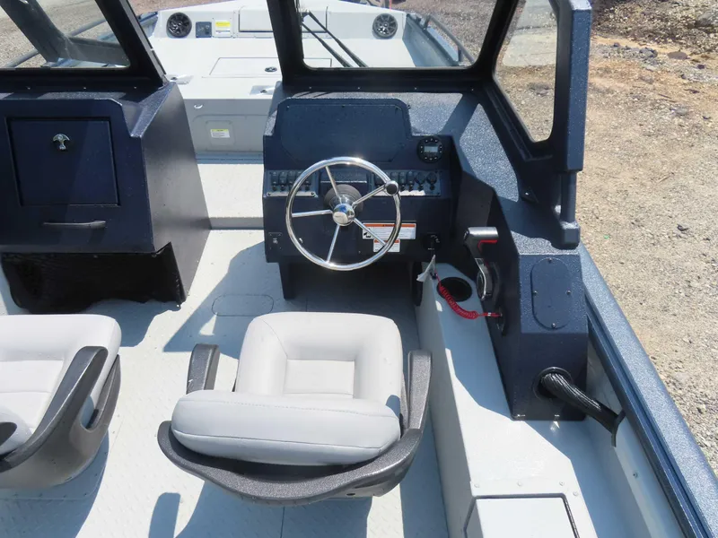 Slide: The Image of 2024 SeaArk Pro Guide 2672 boat interior with steering wheel and seating. - 8