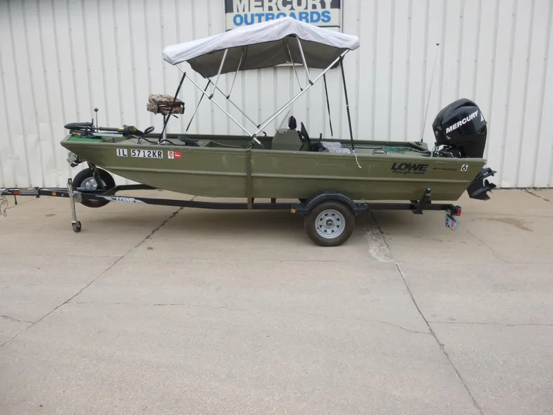 Slide: The Image of 2011 Lowe Roughneck R1760SC boat with canopy and Mercury outboard motor on trailer. - 2