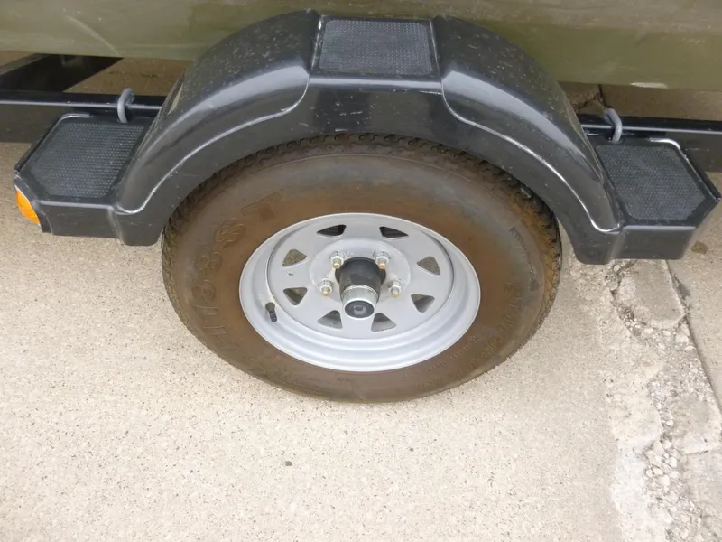 Slide: The Image of Trailer wheel and fender of a 2011 Lowe Roughneck R1760SC boat. - 23