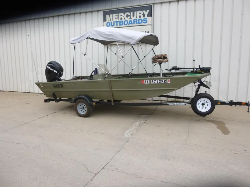 Slide: The Image of 2011 Lowe Roughneck R1760SC boat with canopy on trailer, parked outside Mercury Outboards. - 26