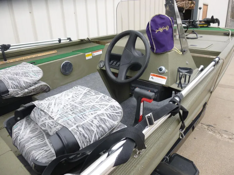 Slide: The Image of 2011 Lowe Roughneck R1760SC boat interior with steering wheel and camo seats. - 27