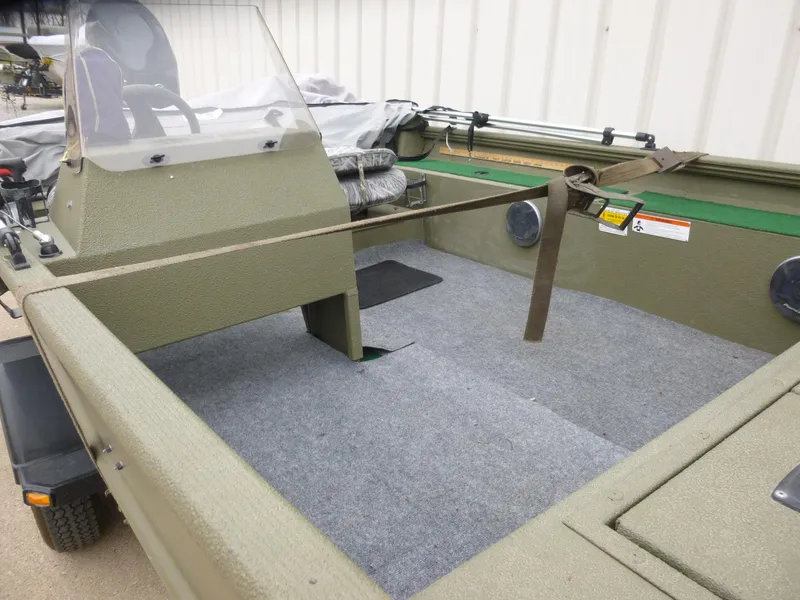 Slide: The Image of 2011 Lowe Roughneck R1760SC boat interior with seating and storage compartments. - 29