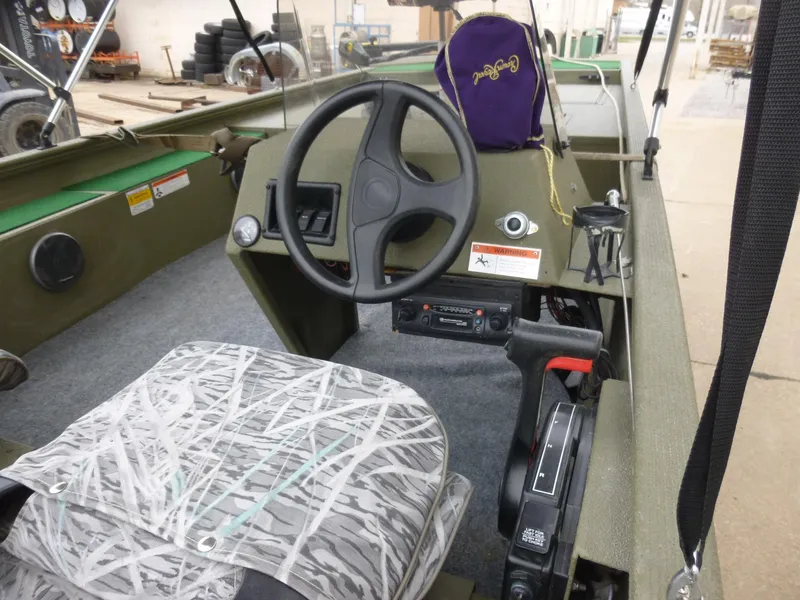 Slide: The Image of 2011 Lowe Roughneck R1760SC boat interior with steering wheel and camo seat. - 3