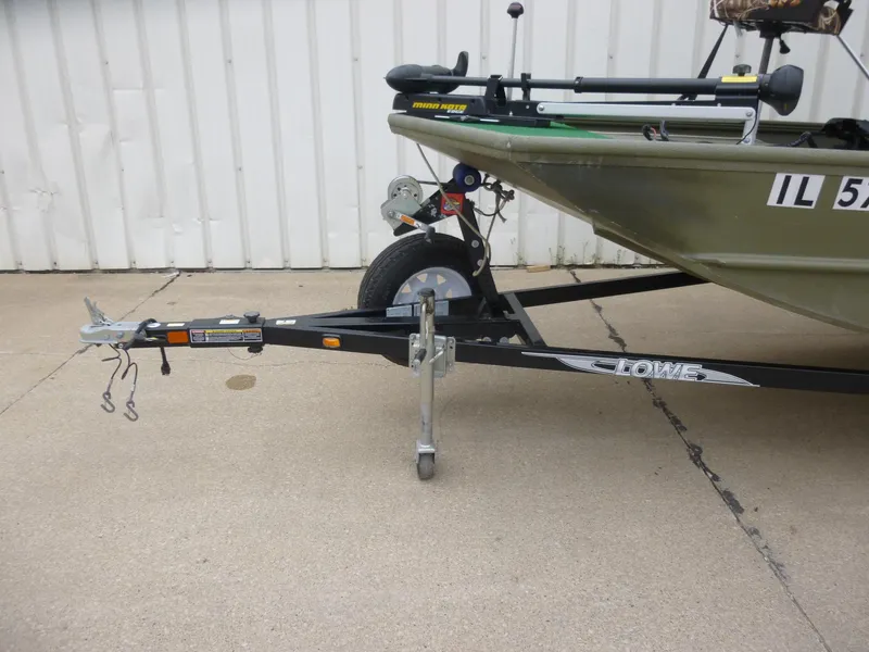 Slide: The Image of 2011 Lowe Roughneck R1760SC boat on trailer, parked on concrete near white wall. - 4