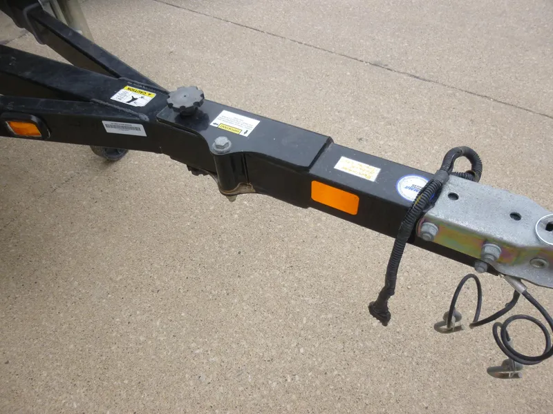 Slide: The Image of Trailer hitch of a 2011 Lowe Roughneck R1760SC boat on concrete surface. - 5