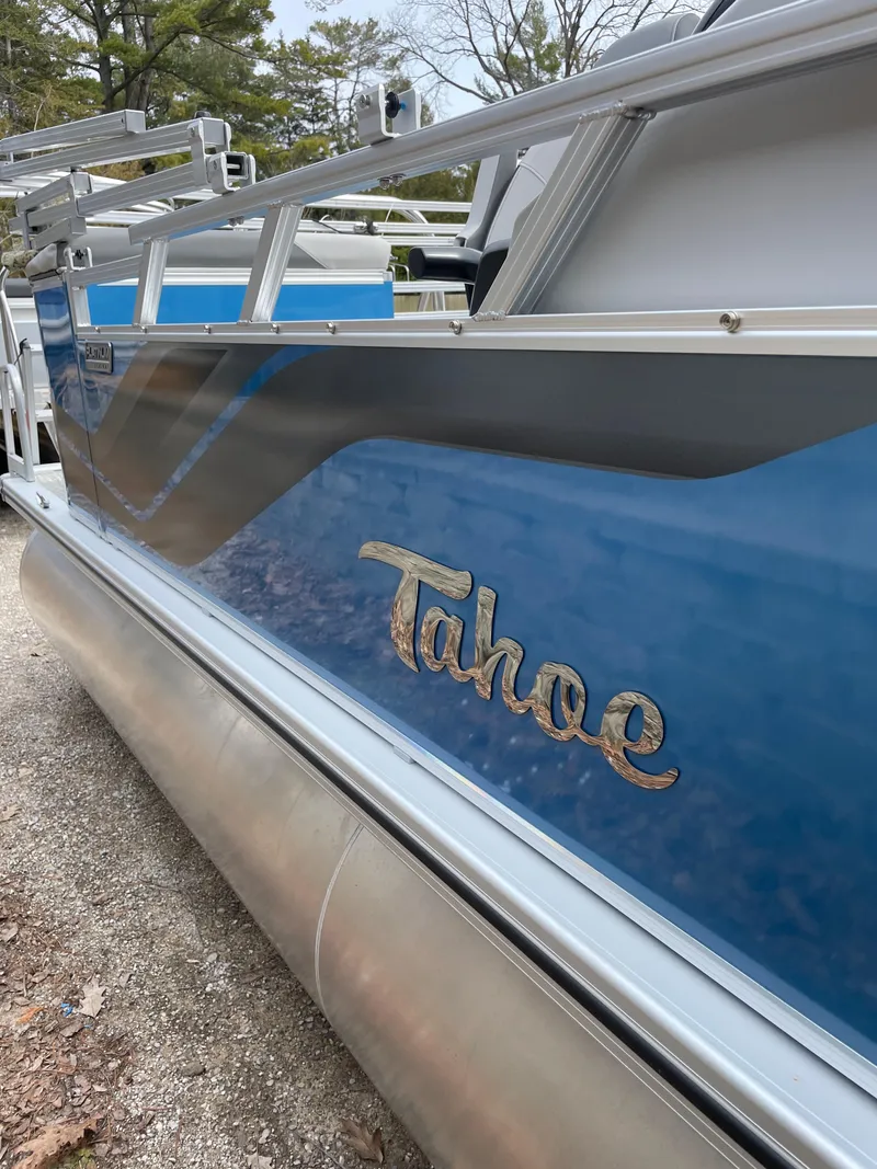 Slide: The Image of 2025 Tahoe 21 Sport 85 pontoon boat with blue and silver design. - 5