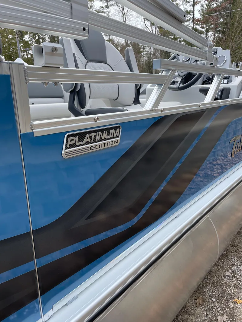 Slide: The Image of 2025 Tahoe 21 Sport 85 Platinum Edition boat with sleek blue and black design. - 7