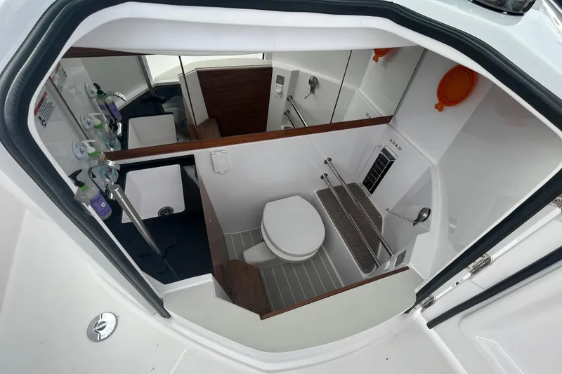 Slide: The Image of 2022 Axopar 28 Cabin Brabus Package bathroom interior with modern amenities. - 11