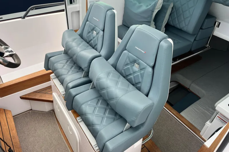 Slide: The Image of Luxurious seating in 2022 Axopar 28 Cabin with Brabus Package, featuring quilted leather upholstery. - 15